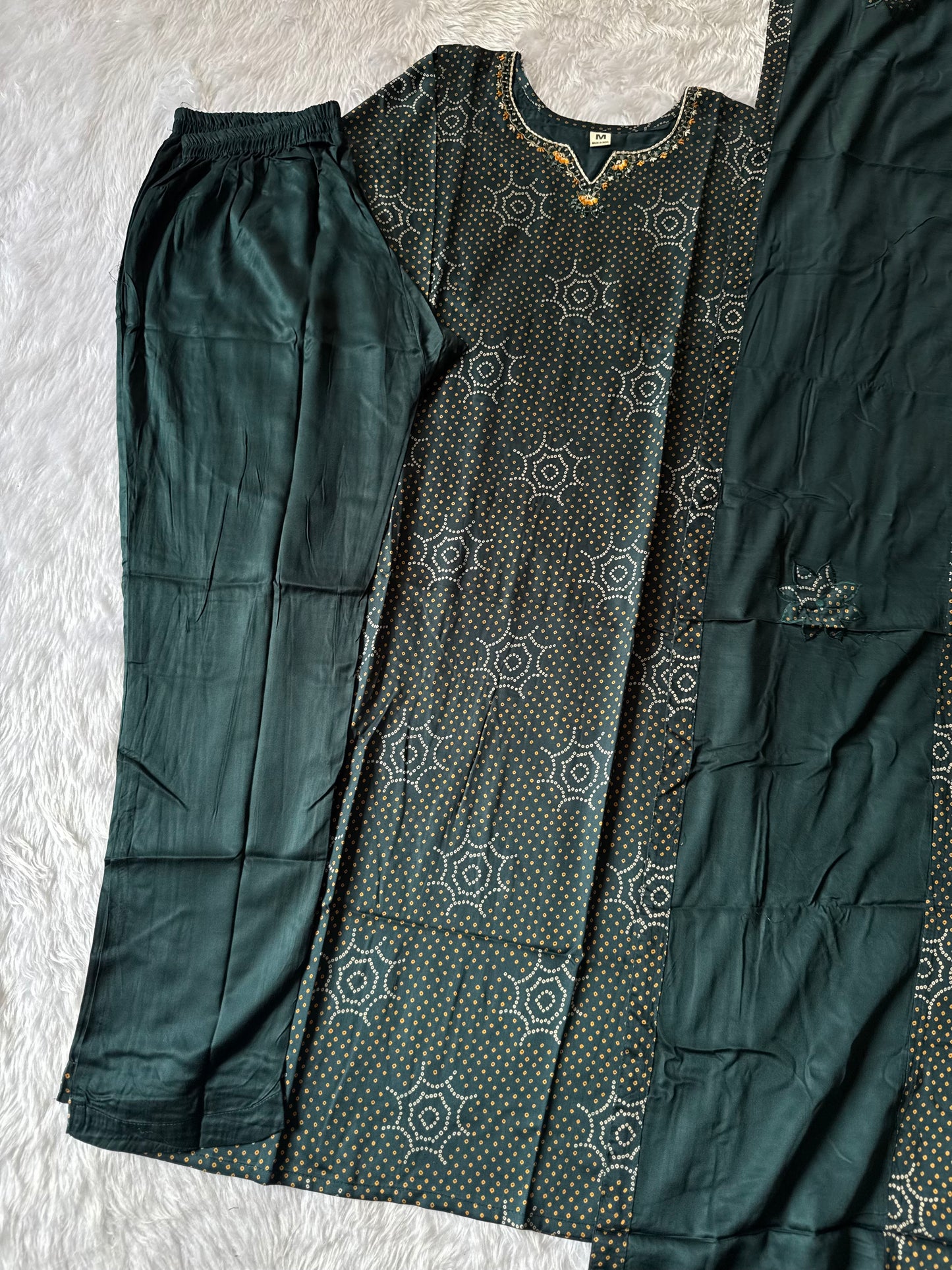 MD-181 this deep Bottle green printed suit set features subtle golden dot motifs with starburst patterns, paired with a plain bottom and dupatta. A perfect blend of tradition and grace for your everyday ethnic charm. ✨
