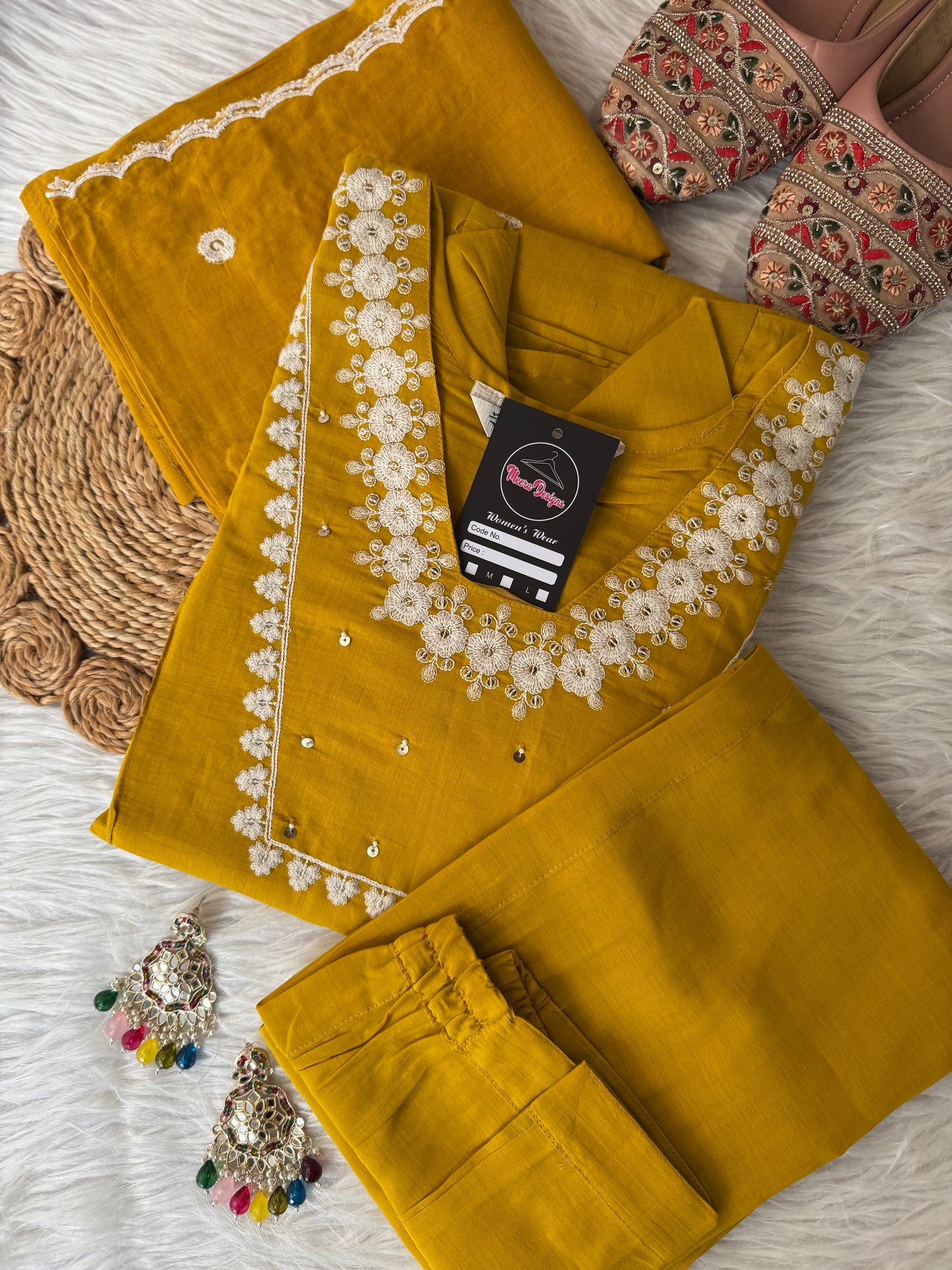 MD-195 This teal embroidered suit set, adorned with delicate floral motifs and mirror accents, blends tradition with elegance — perfect for festive gatherings or serene daytime soirees."