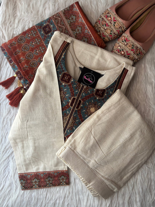 MD-247 This elegant off-white suit set features intricate ethnic embroidery and traditional motifs, perfect for a sophisticated daily look or special occasions.