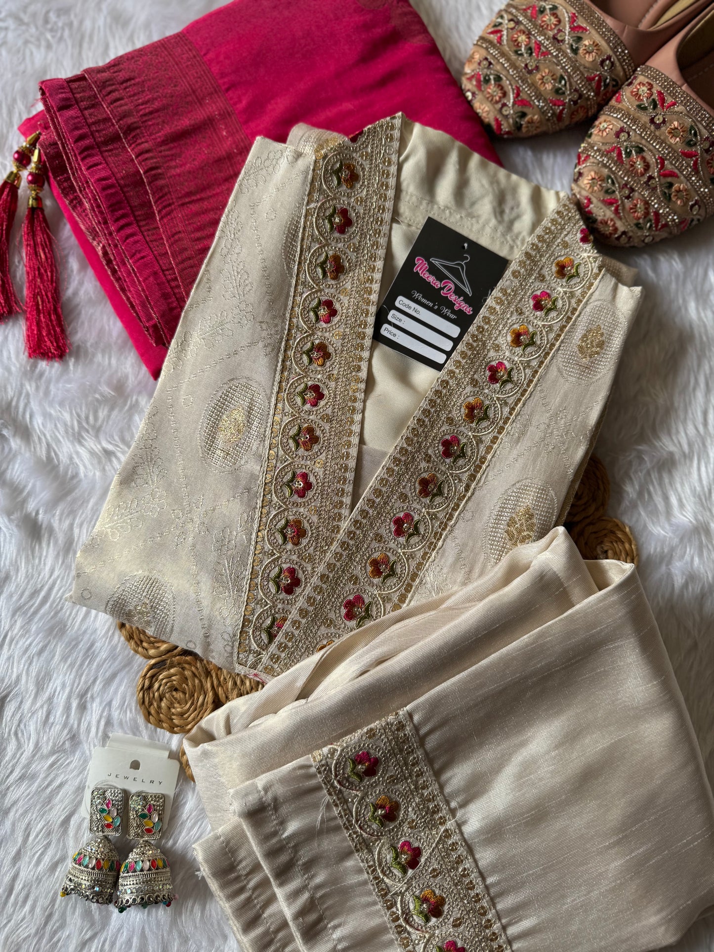 MD-172 This ivory silk set with intricate embroidery, paired with a bold magenta dupatta, is the perfect blend of tradition and timeless grace.