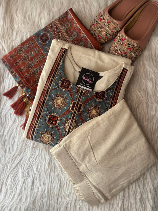 MD-247 This elegant off-white suit set features intricate ethnic embroidery and traditional motifs, perfect for a sophisticated daily look or special occasions.