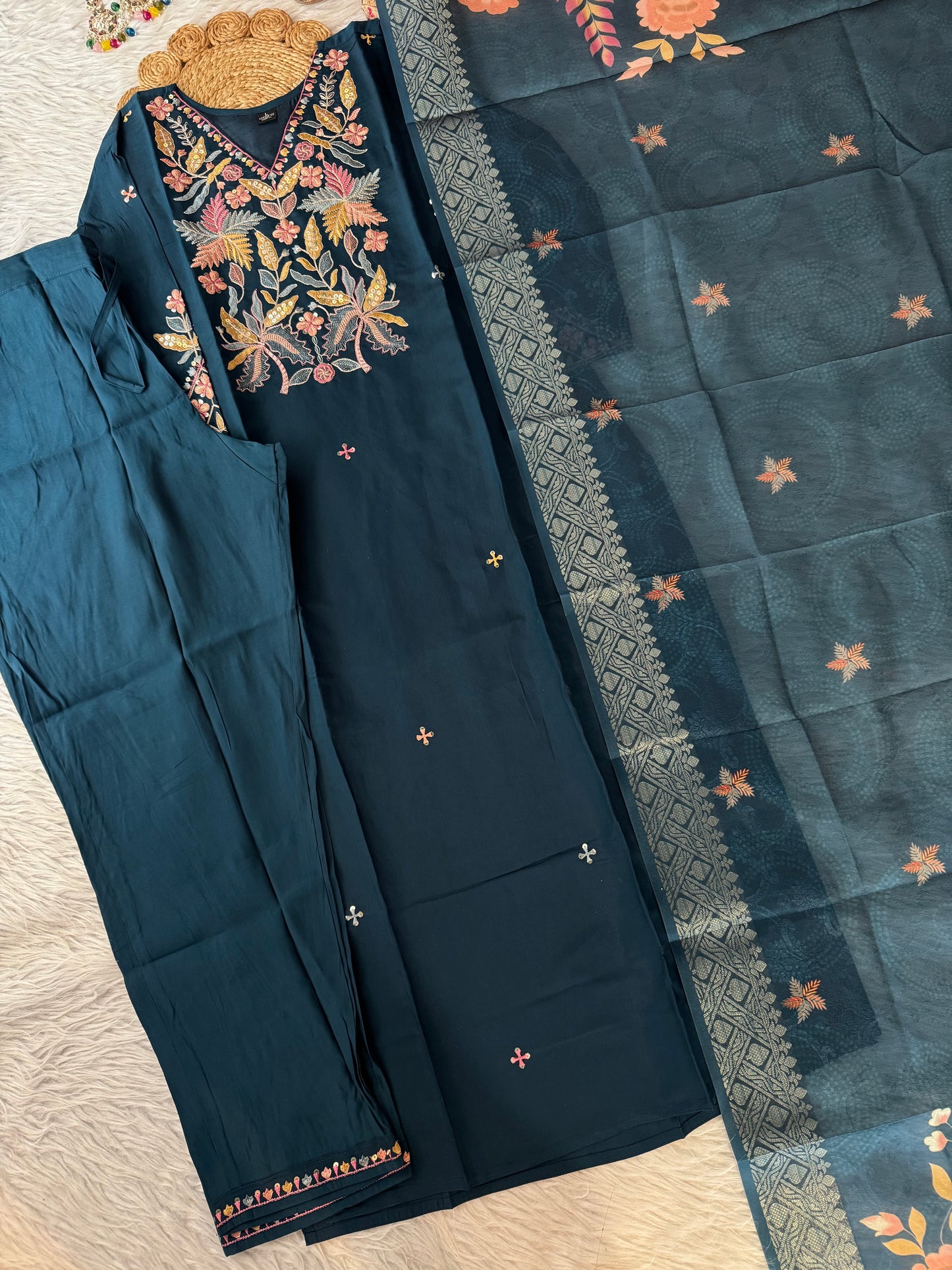 MD-192 This elegant beige suit set features exquisite thread and sequin embroidery on the neckline, paired with subtle mirror detailing and a woven dupatta adorned with delicate motifs — a timeless blend of tradition and charm."