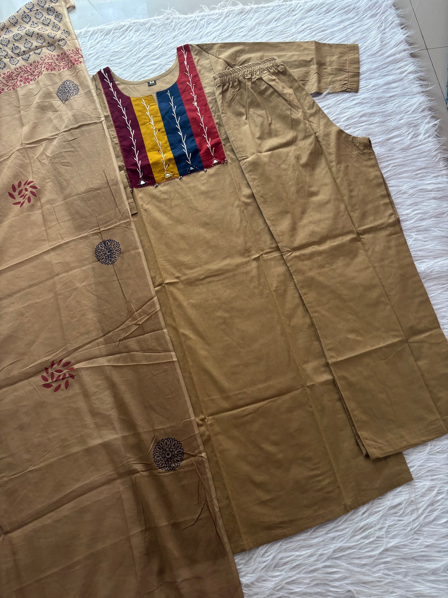 MD-231 This stylish three-piece ethnic set offers a blend of neutral tones and vibrant accents, making it a versatile choice for both casual outings and festive gatherings.
