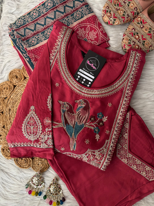 MD-202 Elegant traditional outfit featuring intricate embroidery with a charming bird motif on the neckline. Paired with matching trousers and a beautifully patterned dupatta, this ensemble blends nature-inspired art with classic style for a g