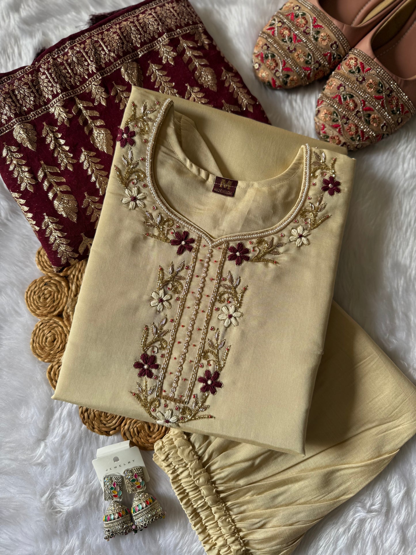 MD-177 this pastel cream white suit set, adorned with delicate floral embroidery, is perfectly paired with a rich maroon dupatta featuring golden motifs. A timeless ensemble for graceful festive moments. ✨🌸