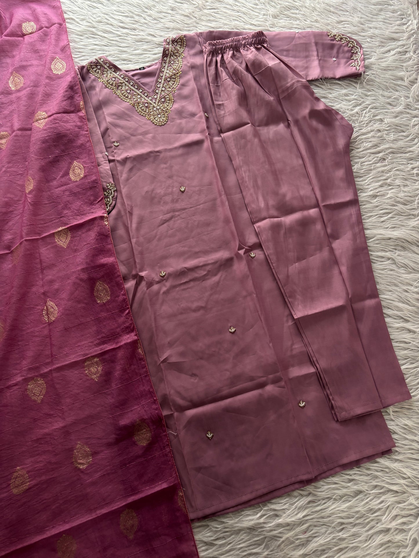 MD-263 The mauve hue of this ethnic set is absolutely stunning! The intricate embroidery on the neckline and sleeves gives it such a sophisticated look. Here are a few caption options for your post, ranging from elegant to more casual
