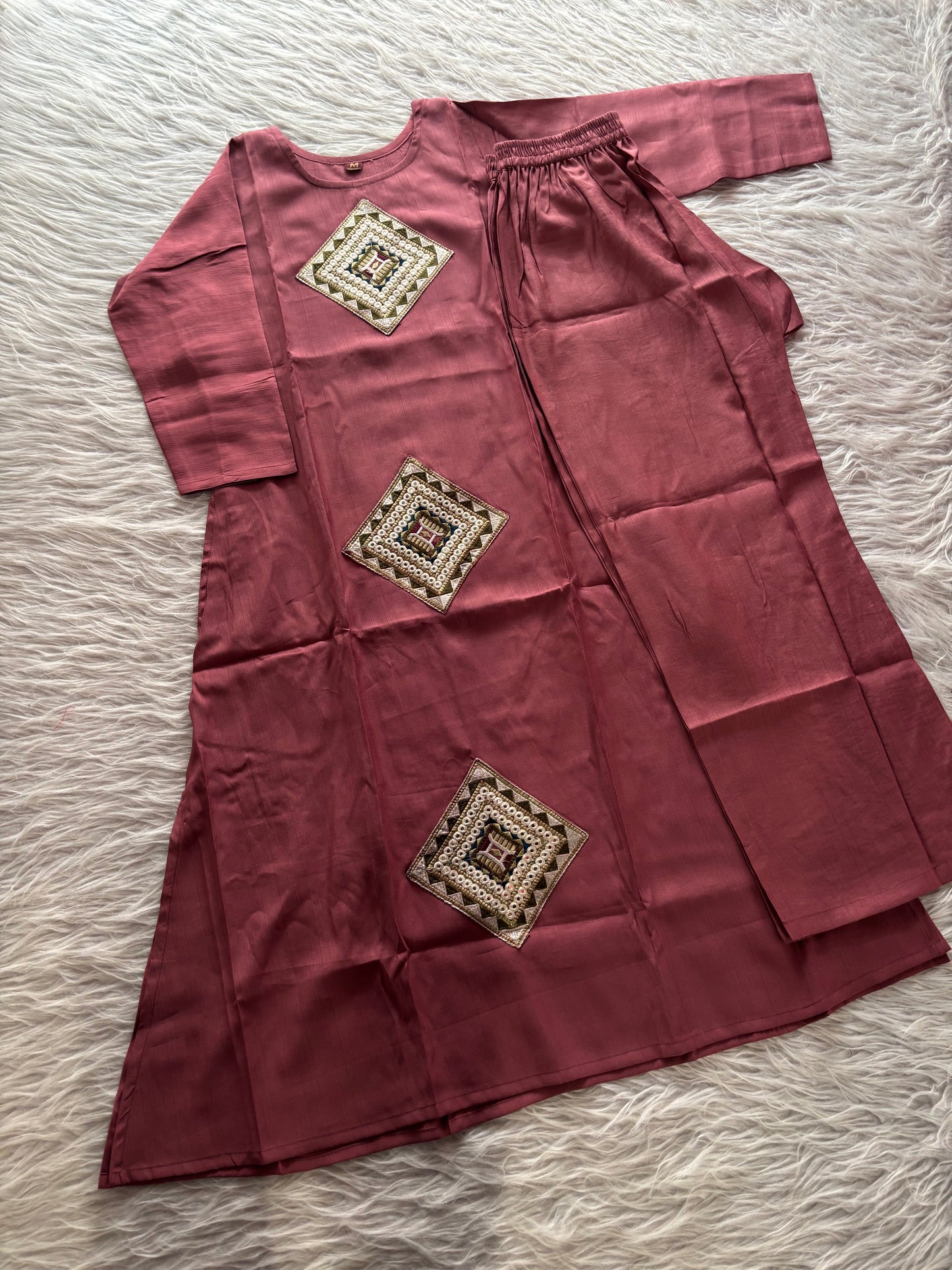 MD-234 This kurta set features striking geometric patchwork, blending traditional craftsmanship with a clean, contemporary silhouette. Perfect for those who appreciate the beauty of subtle details.