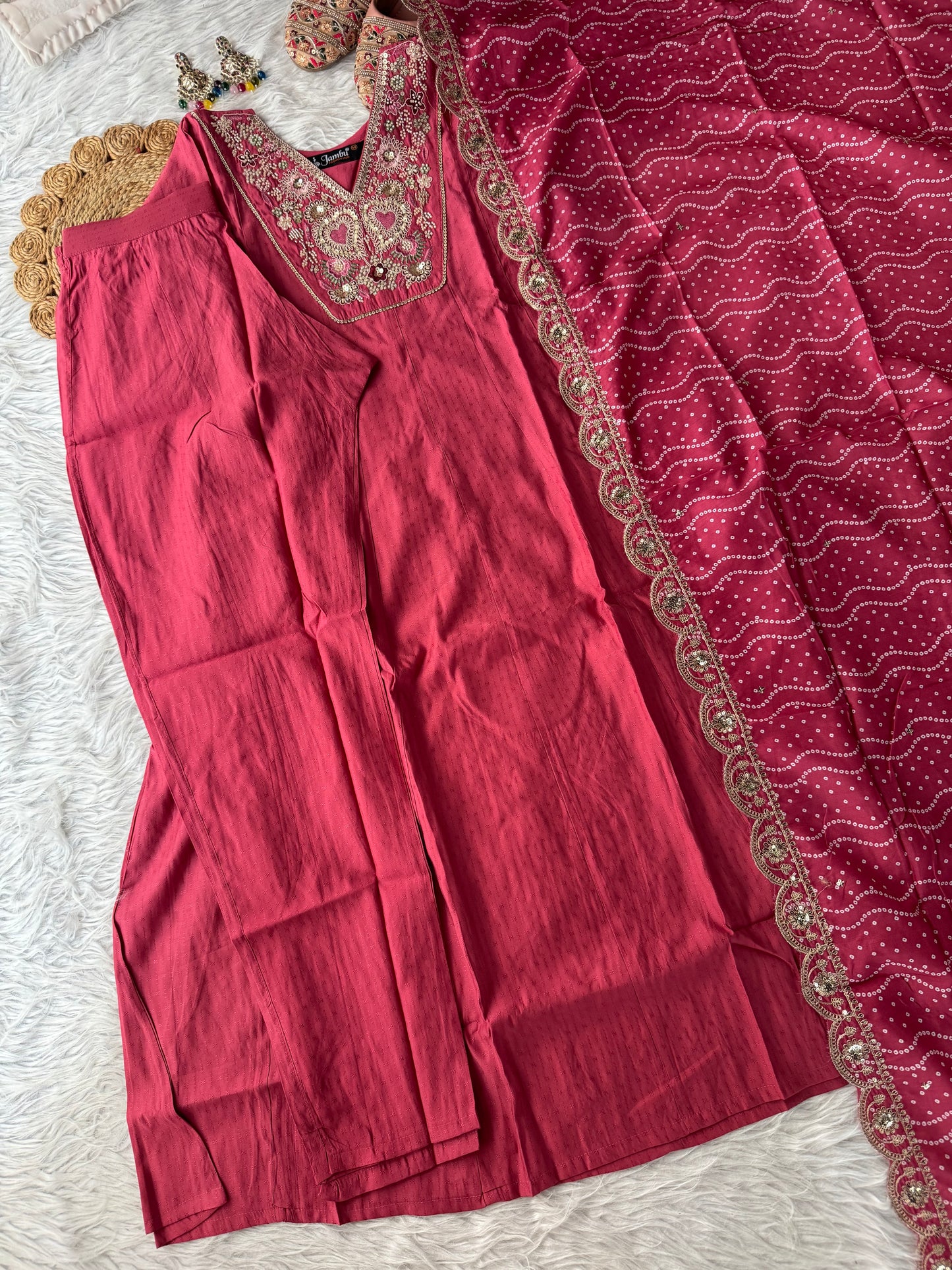 MD-198 This suit set features intricate thread embroidery with heart motifs and a stunning bandhani dupatta edged in golden lace — perfect for festive moments and timeless grace."