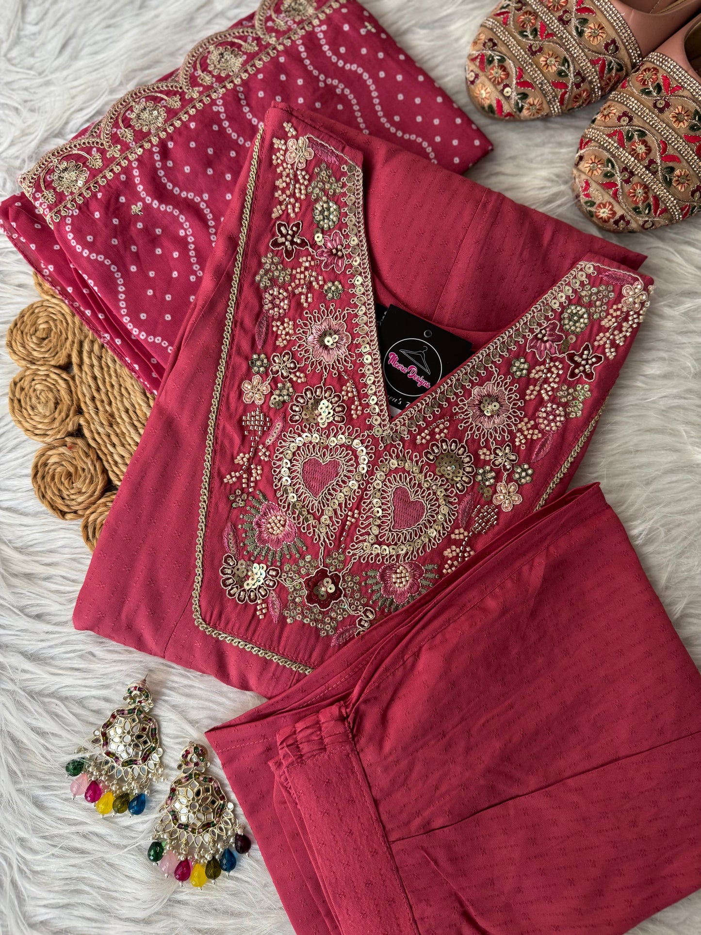MD-198 This suit set features intricate thread embroidery with heart motifs and a stunning bandhani dupatta edged in golden lace — perfect for festive moments and timeless grace."
