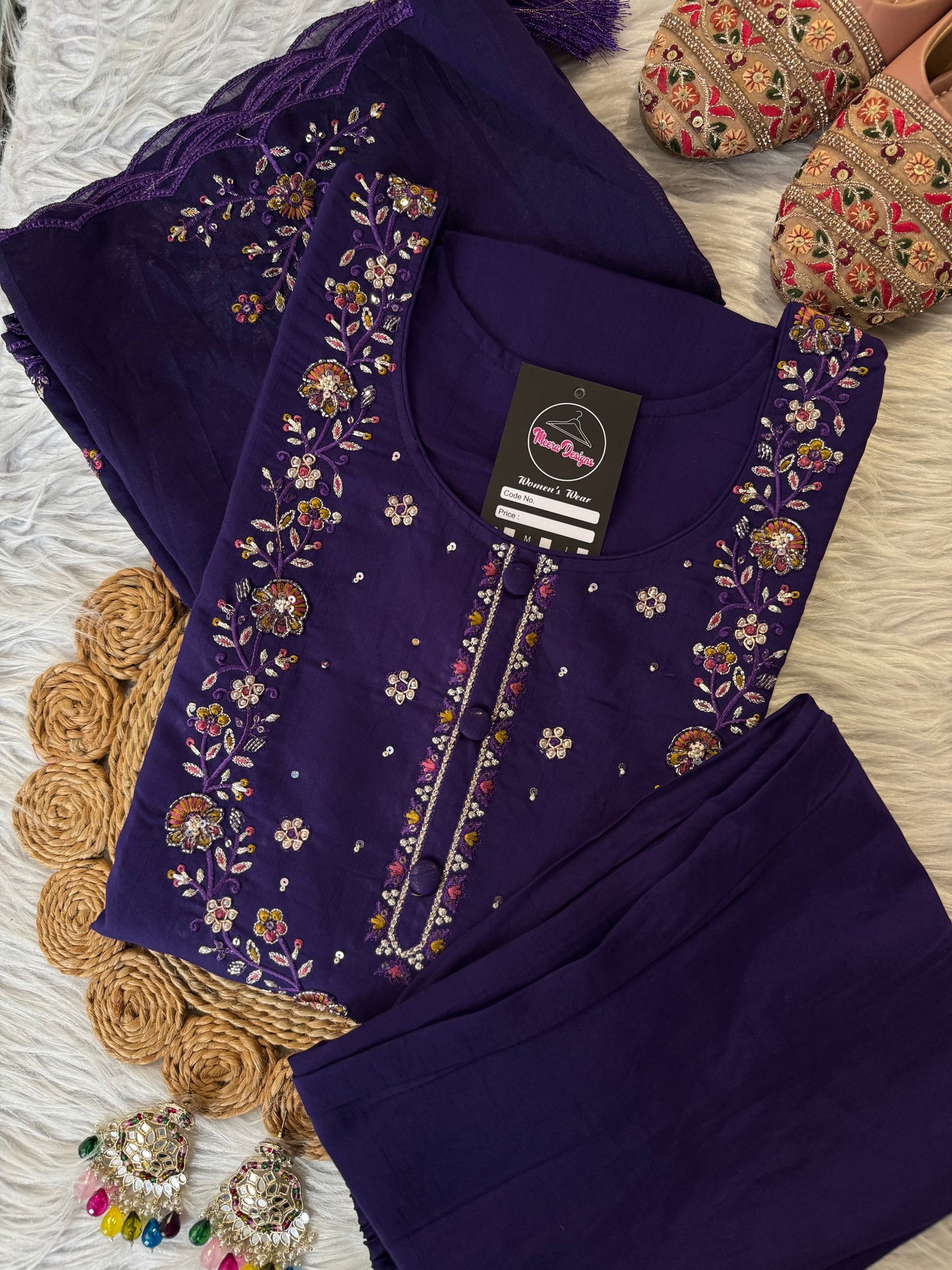 MD-209 "Elegance in every detail ✨ This deep purple suit with delicate floral embroidery is a perfect blend of grace and tradition 🌸💜"
Would you like me to give you a few more short caption options to choose from?