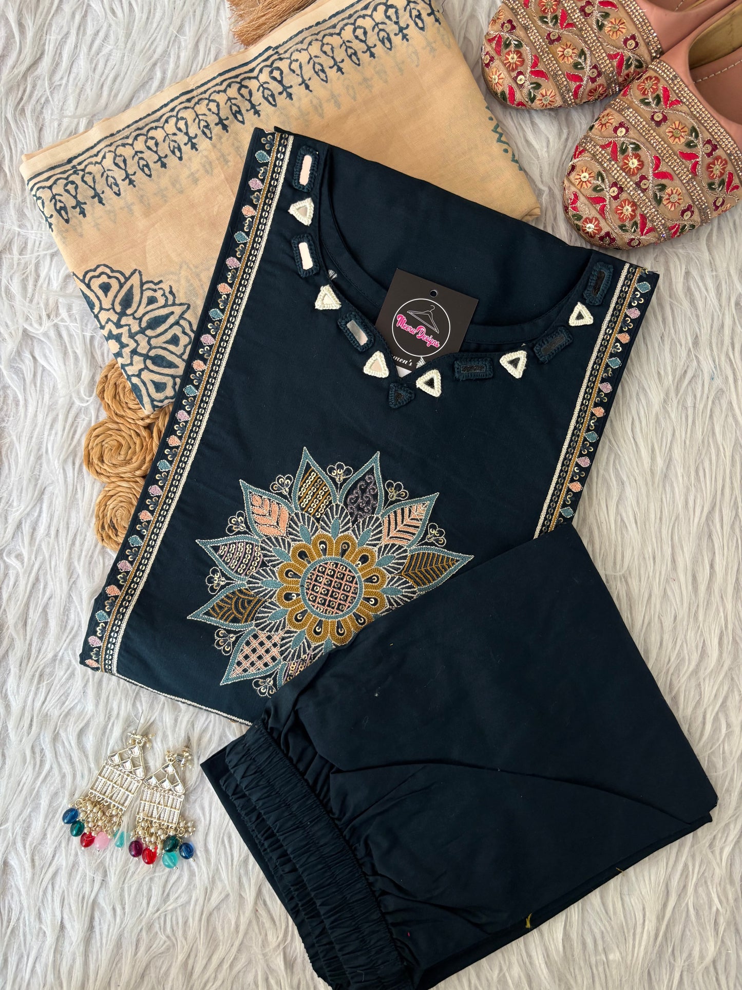 MD-265 This elegant three-piece ethnic set features a deep Kurti and matching trousers, paired with a contrasting cream-colored Dupatta. The ensemble balances rich, solid tones with intricate traditional detailing, making it ideal for festive