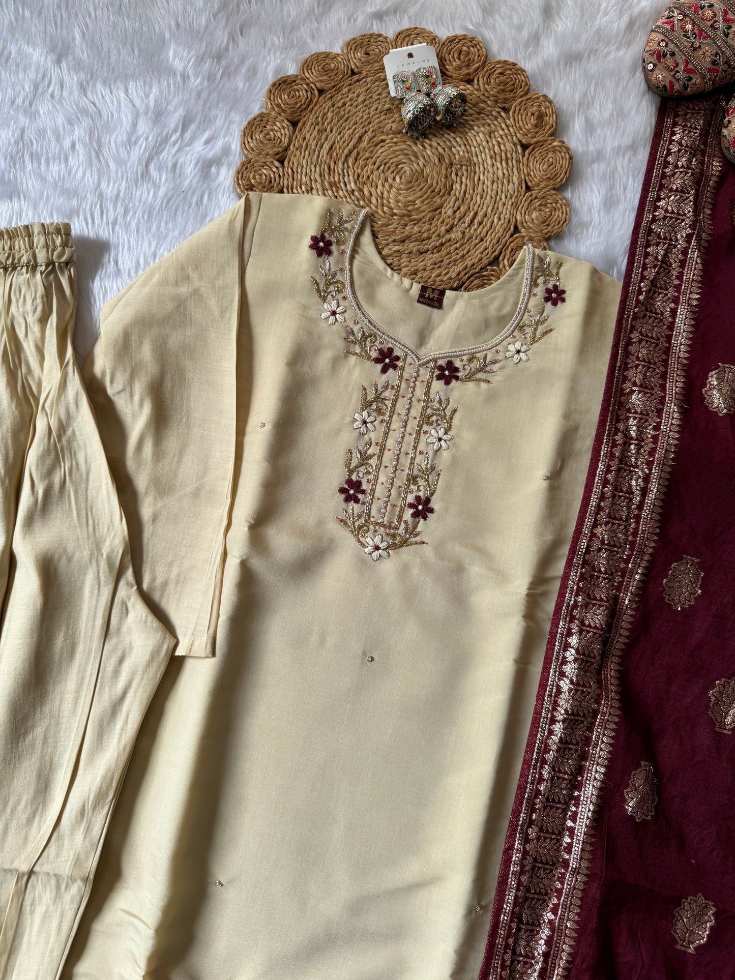 MD-177 this pastel cream white suit set, adorned with delicate floral embroidery, is perfectly paired with a rich maroon dupatta featuring golden motifs. A timeless ensemble for graceful festive moments. ✨🌸