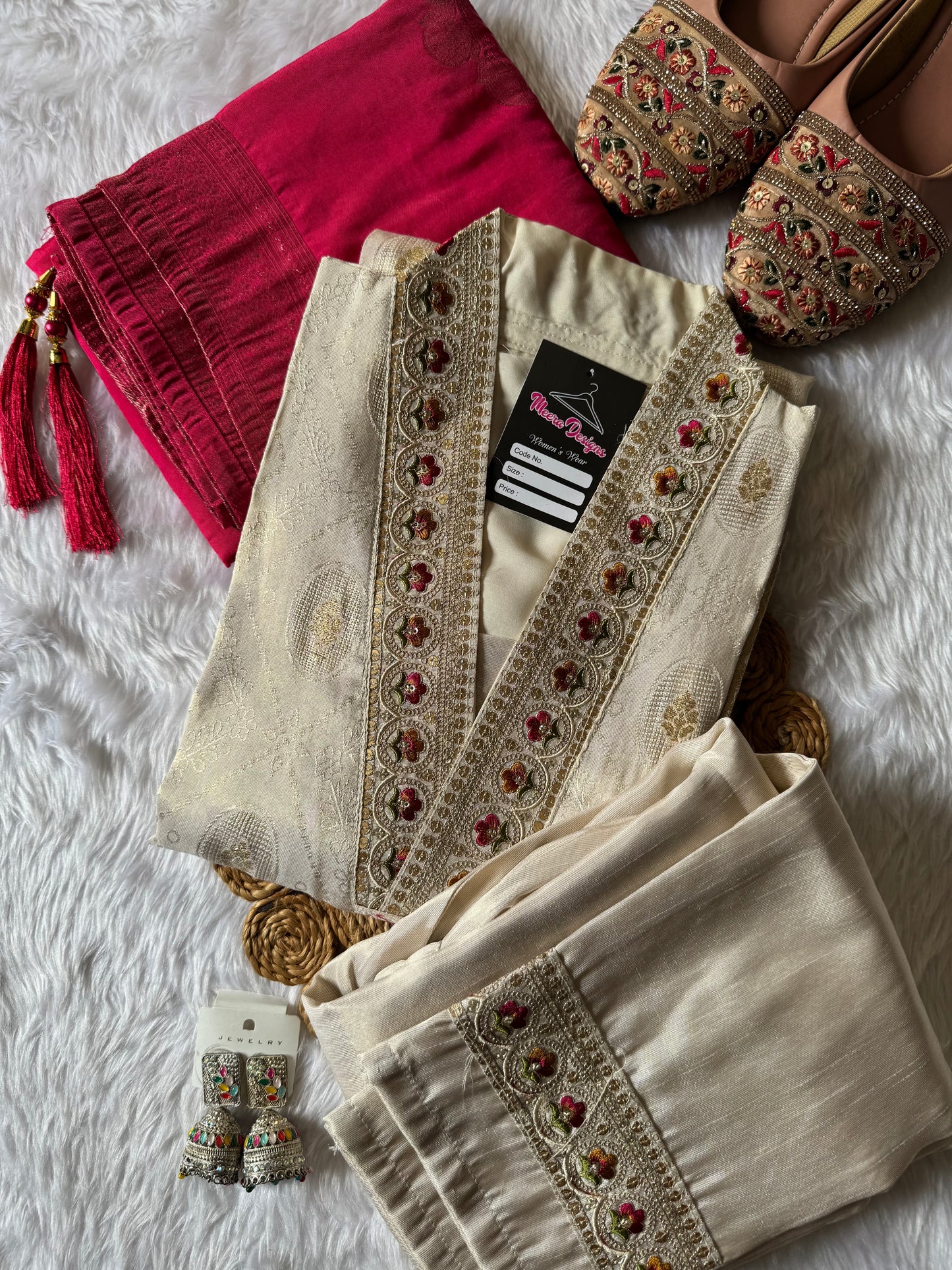 MD-172 This ivory silk set with intricate embroidery, paired with a bold magenta dupatta, is the perfect blend of tradition and timeless grace.