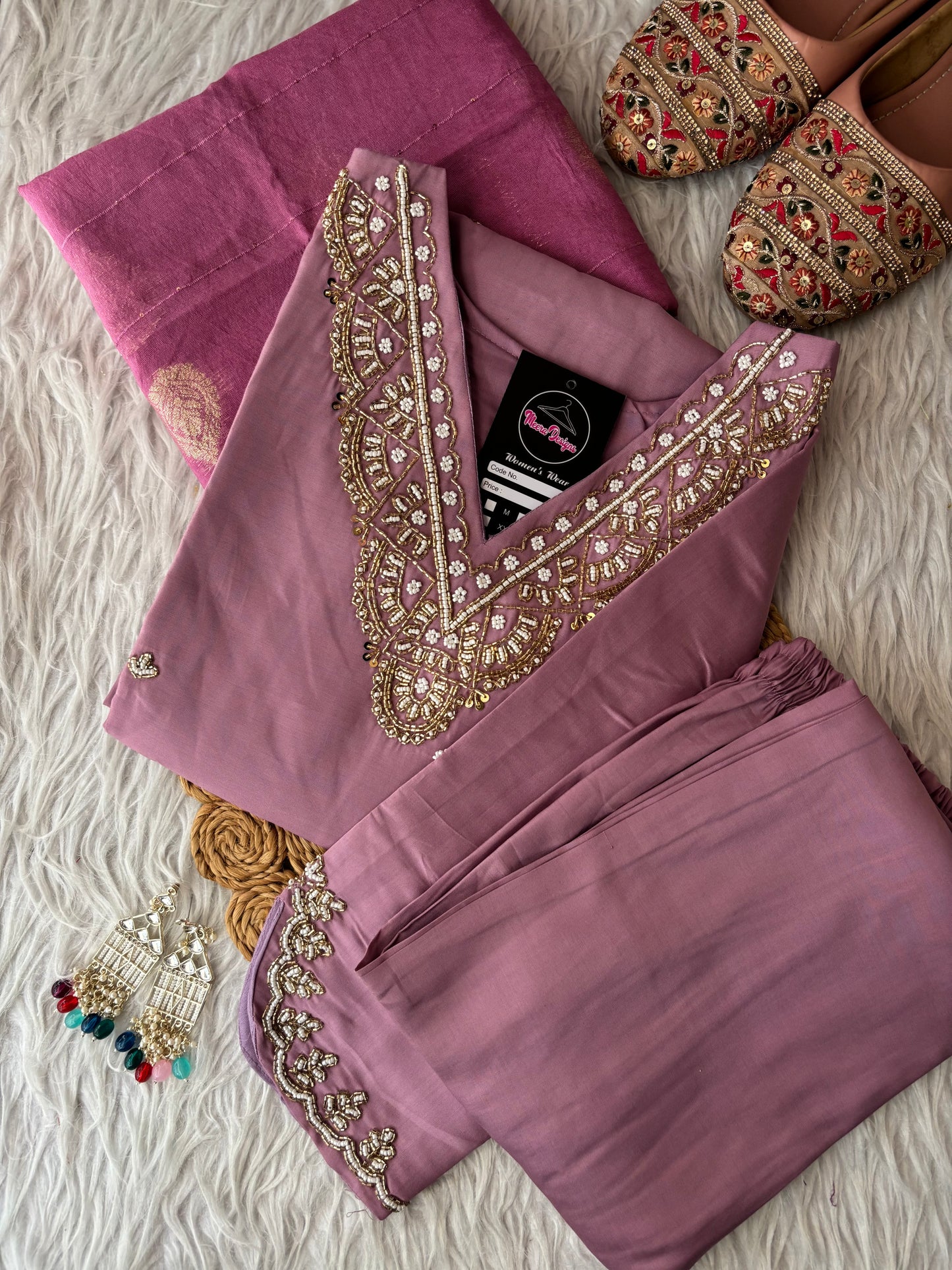 MD-263 The mauve hue of this ethnic set is absolutely stunning! The intricate embroidery on the neckline and sleeves gives it such a sophisticated look. Here are a few caption options for your post, ranging from elegant to more casual