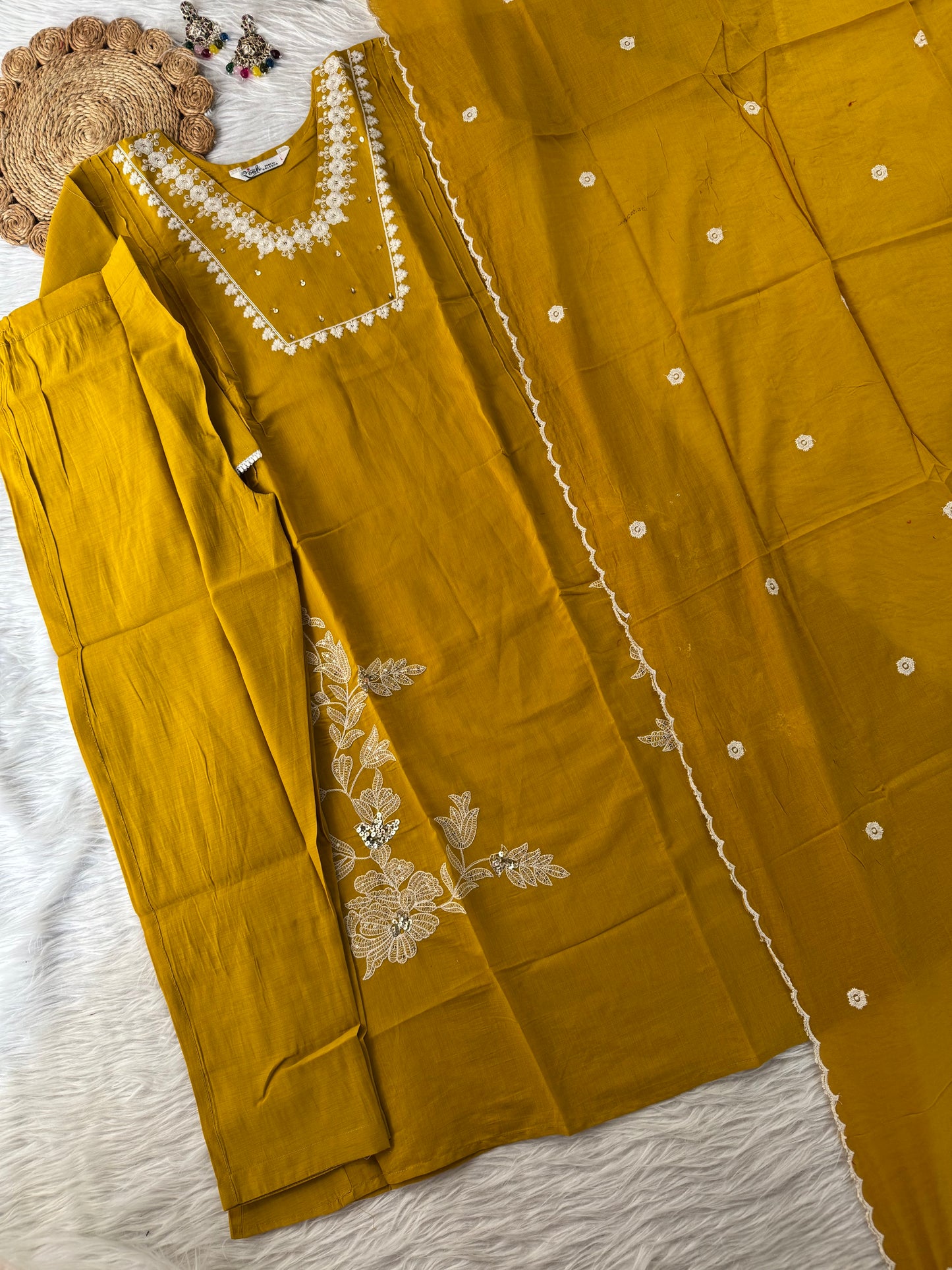 MD-195 This teal embroidered suit set, adorned with delicate floral motifs and mirror accents, blends tradition with elegance — perfect for festive gatherings or serene daytime soirees."