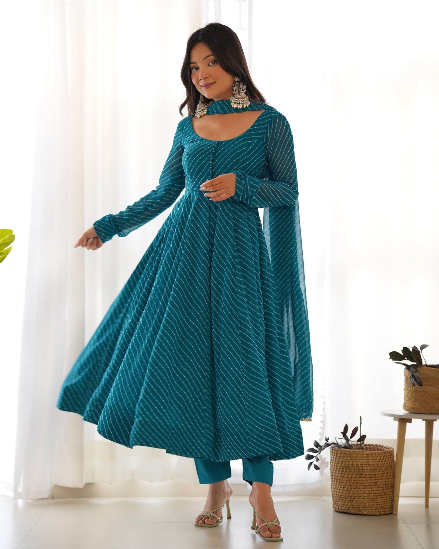 MD-246 Step into a world of grace and sophistication with this stunning teal Leheriya-patterned Anarkali set. Perfect for festive celebrations or an elegant evening out, this ensemble strikes the perfect balance between traditional craftsmanship and moder