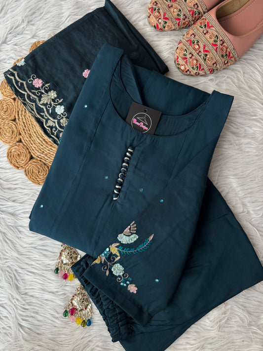 MD-194 "Unveil timeless grace in this deep plum ethnic suit, adorned with intricate floral embroidery in soft pinks and greens. Perfectly balanced between elegance and tradition, it’s a wardrobe essential for festive moments."