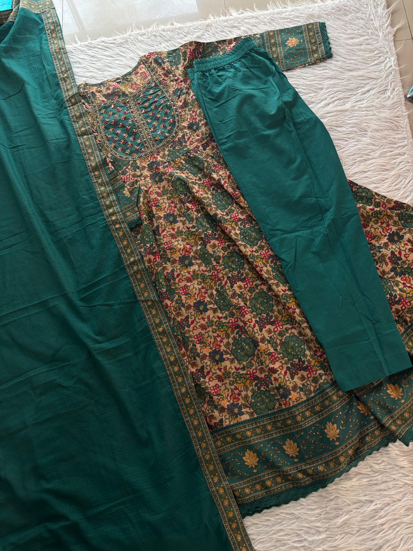 MD-273 "Embracing timeless tradition with a modern twist. Loving the rich hues, intricate Kalamkari-inspired prints, and delicate mirror work on this gorgeous tiered suit set. ✨💛"