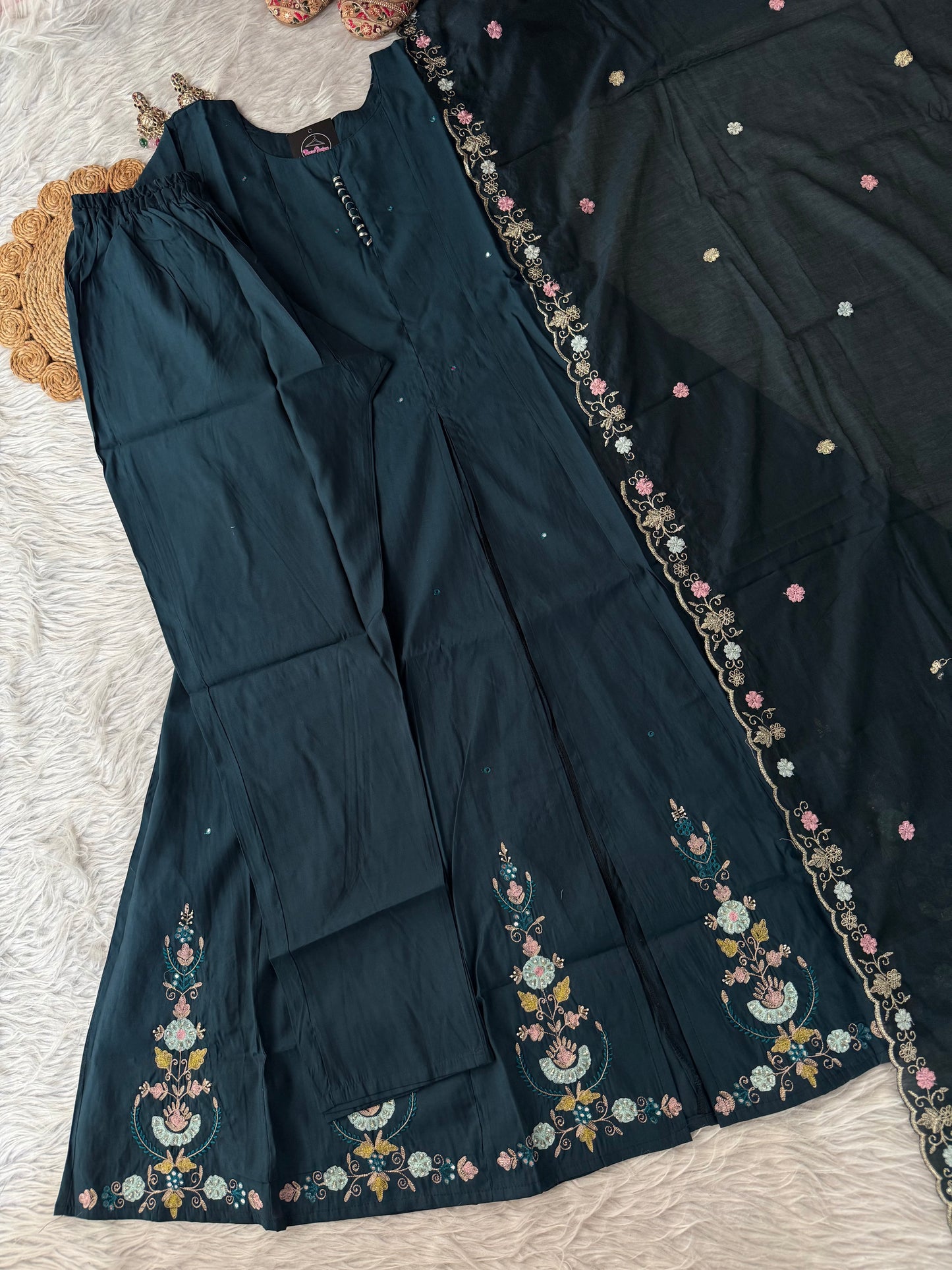 MD-194 "Unveil timeless grace in this deep plum ethnic suit, adorned with intricate floral embroidery in soft pinks and greens. Perfectly balanced between elegance and tradition, it’s a wardrobe essential for festive moments."