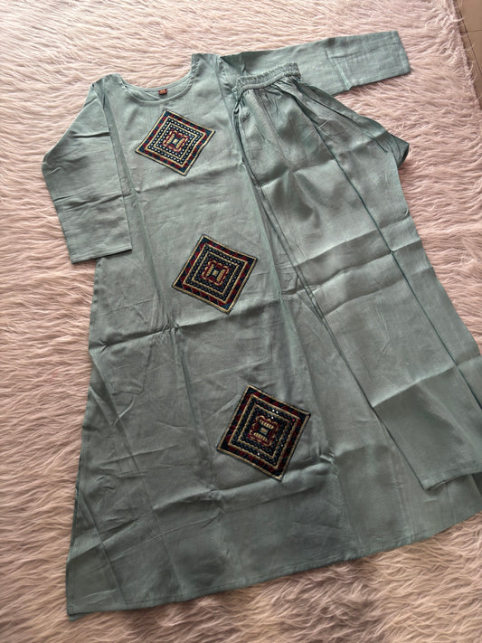 MD-234 This kurta set features striking geometric patchwork, blending traditional craftsmanship with a clean, contemporary silhouette. Perfect for those who appreciate the beauty of subtle details.