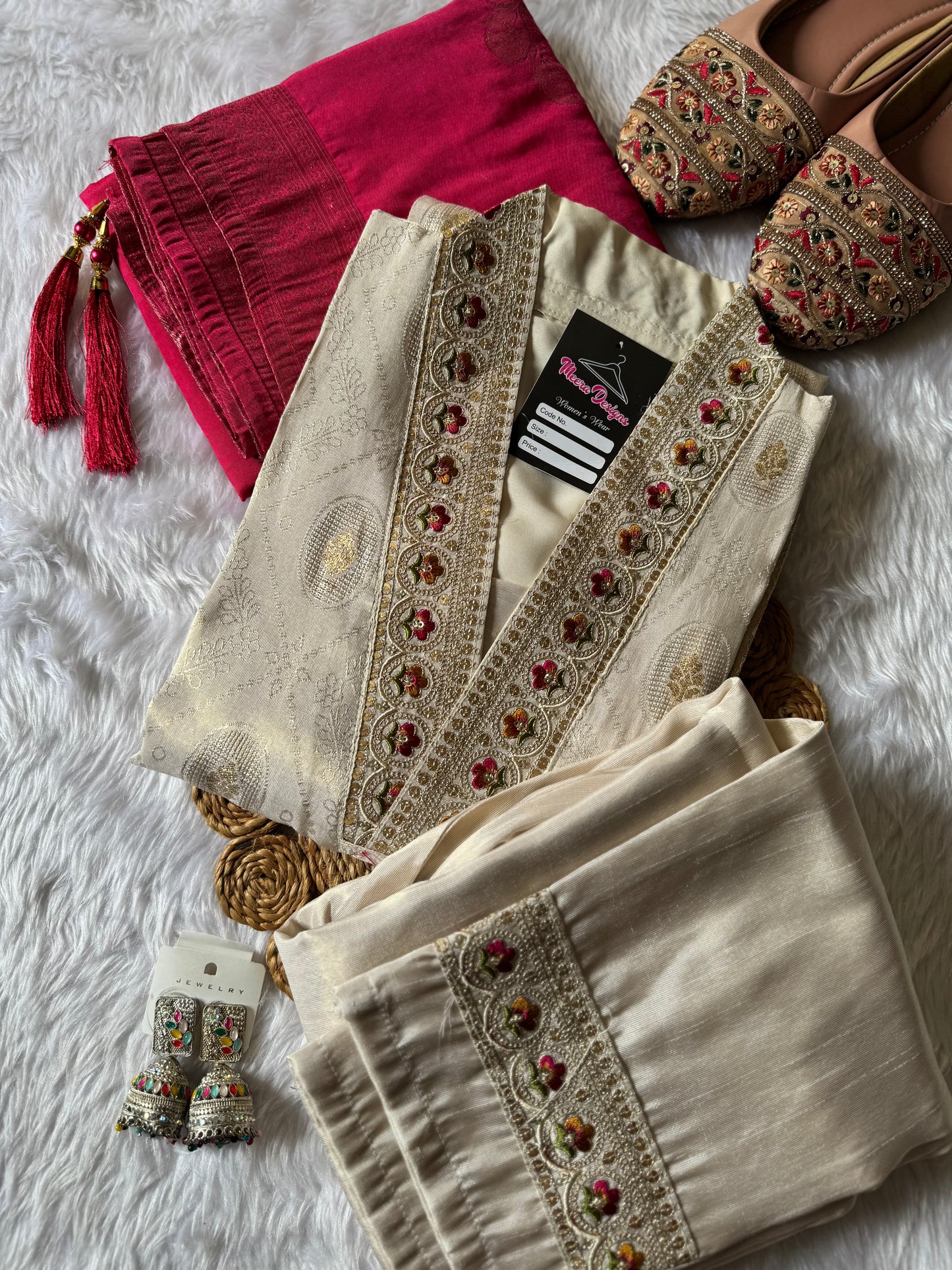 MD-172 This ivory silk set with intricate embroidery, paired with a bold magenta dupatta, is the perfect blend of tradition and timeless grace.