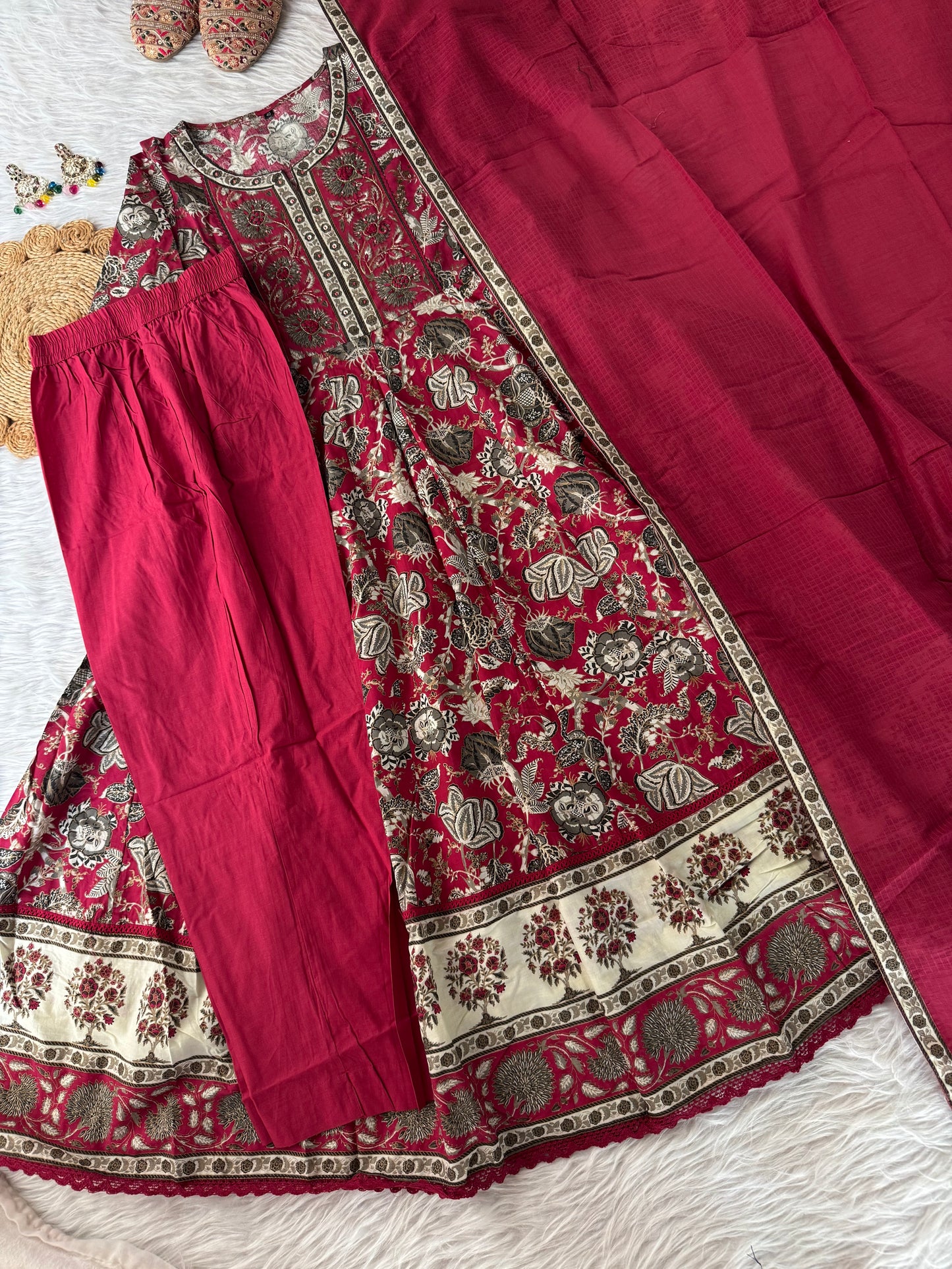 MD-190 
"Grace meets grandeur in this deep Rani pink  Anarkali set, featuring intricate floral prints and traditional borders — a perfect pick for festive charm and timeless elegance."
