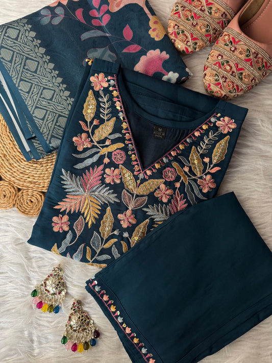 MD-192 This elegant beige suit set features exquisite thread and sequin embroidery on the neckline, paired with subtle mirror detailing and a woven dupatta adorned with delicate motifs — a timeless blend of tradition and charm."