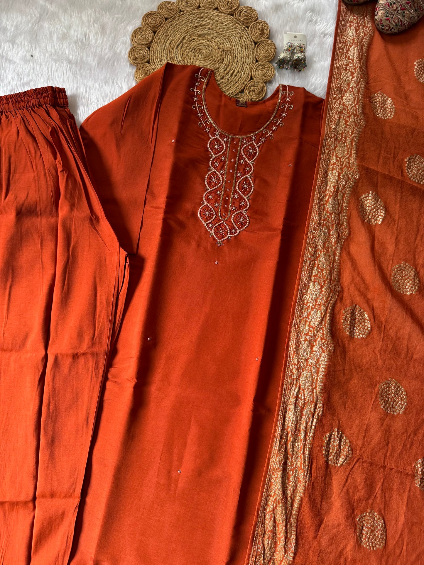 MD-176 This rust orange ethnic set, adorned with delicate embroidery and a touch of golden elegance, is your perfect pick for festive flair and timeless charm."