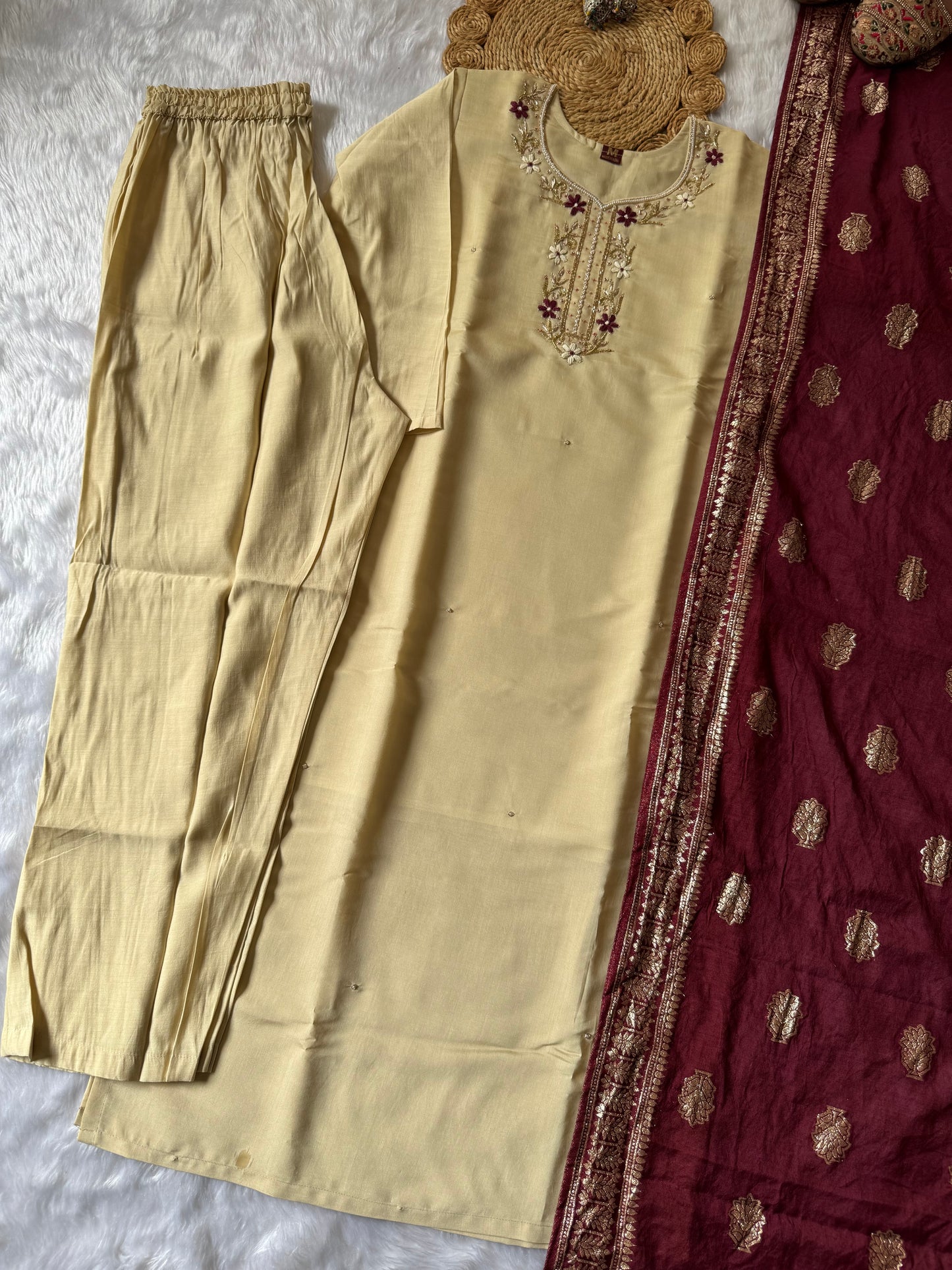 MD-177 this pastel cream white suit set, adorned with delicate floral embroidery, is perfectly paired with a rich maroon dupatta featuring golden motifs. A timeless ensemble for graceful festive moments. ✨🌸
