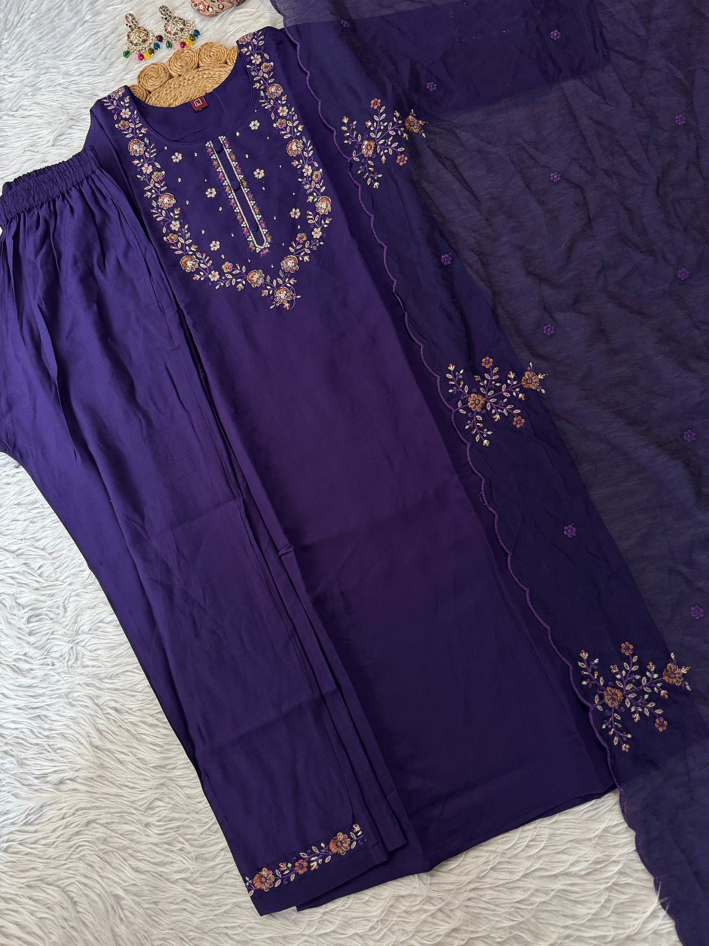 MD-209 "Elegance in every detail ✨ This deep purple suit with delicate floral embroidery is a perfect blend of grace and tradition 🌸💜"
Would you like me to give you a few more short caption options to choose from?