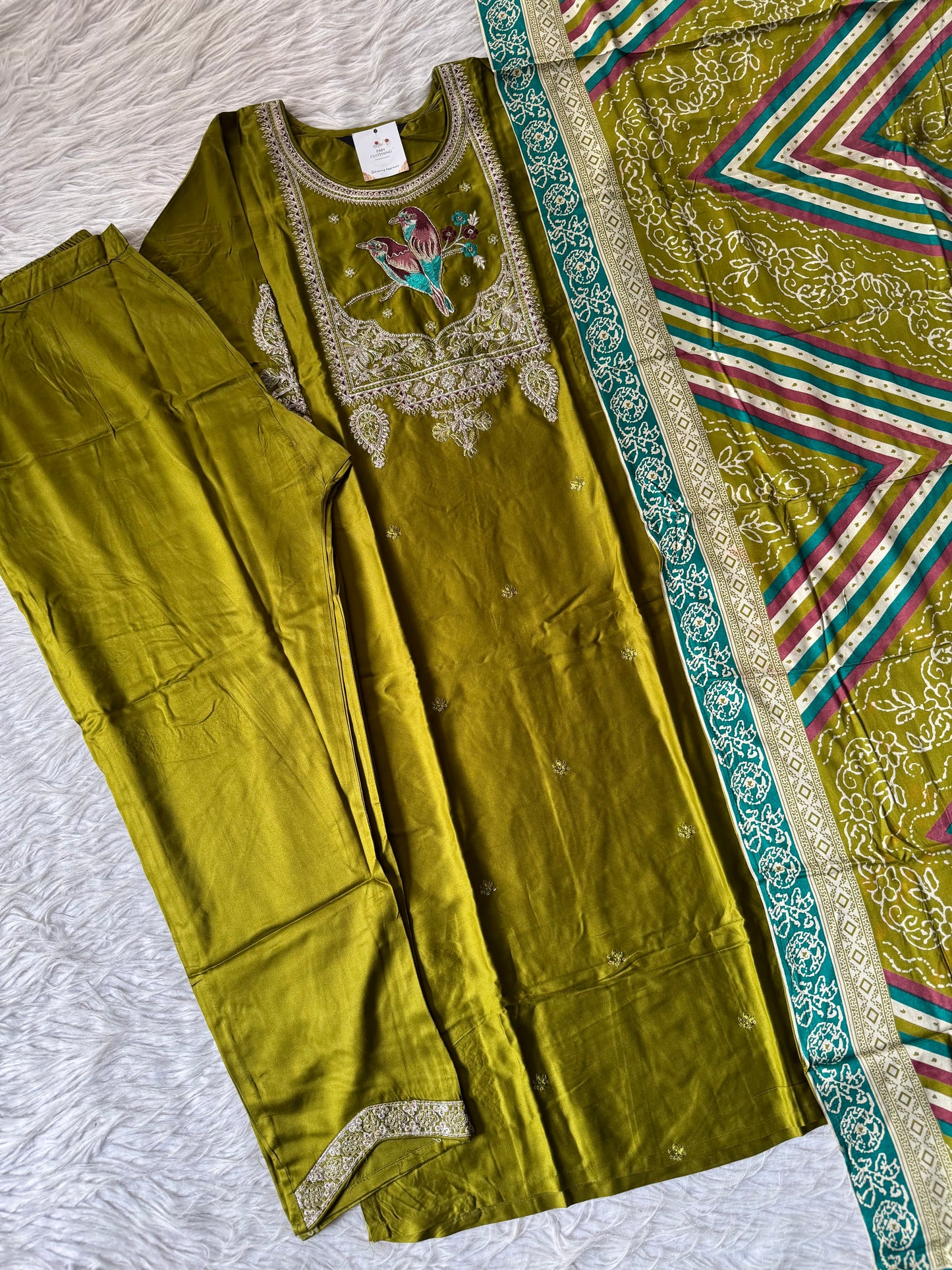 MD-202 Elegant traditional outfit featuring intricate embroidery with a charming bird motif on the neckline. Paired with matching trousers and a beautifully patterned dupatta, this ensemble blends nature-inspired art with classic style for a g