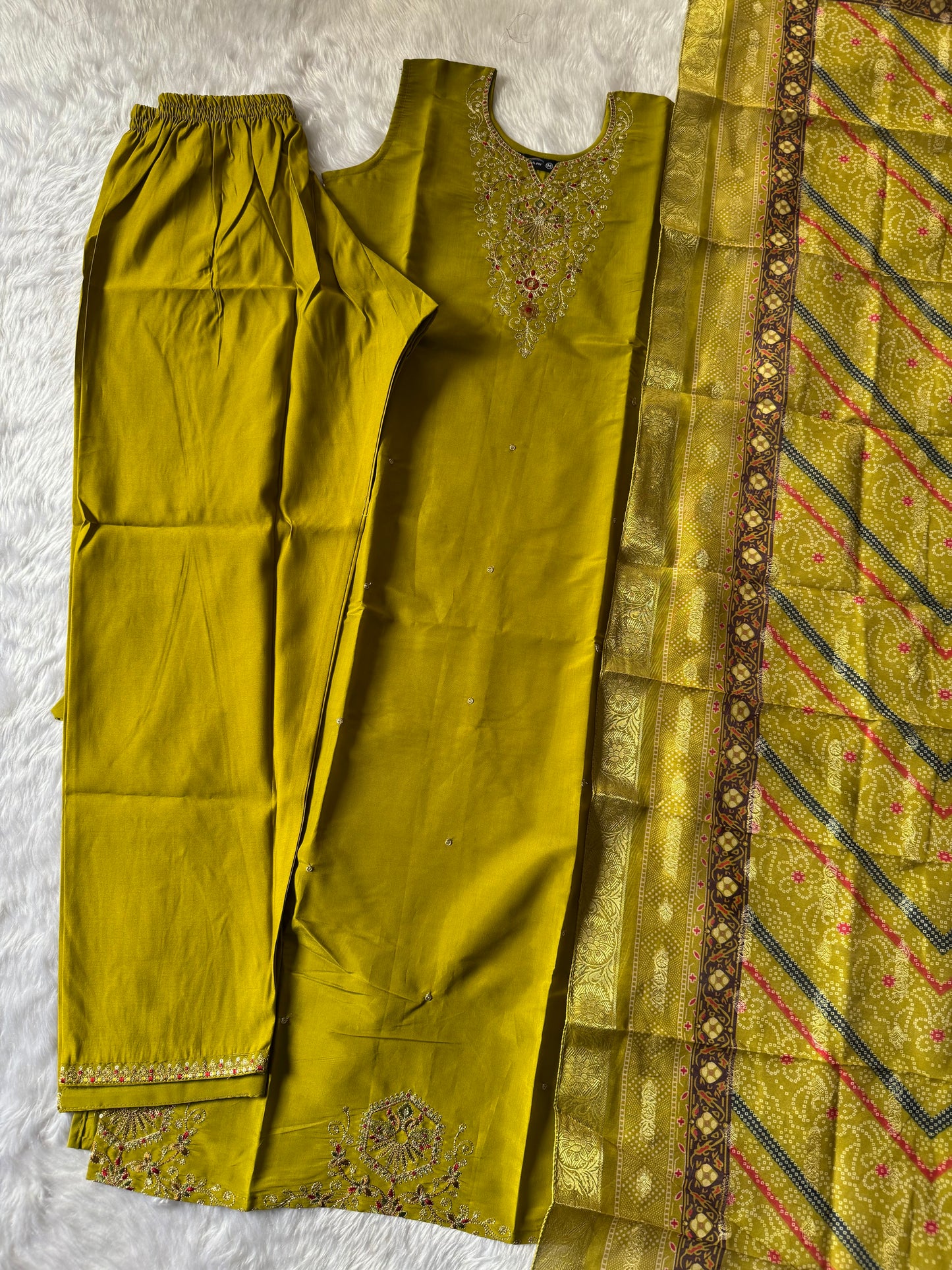 MD-187 this mustard green suit set features intricate neckline embroidery paired with a rich Banarasi dupatta, making it an exquisite choice for festive occasions and celebrations. ✨💛