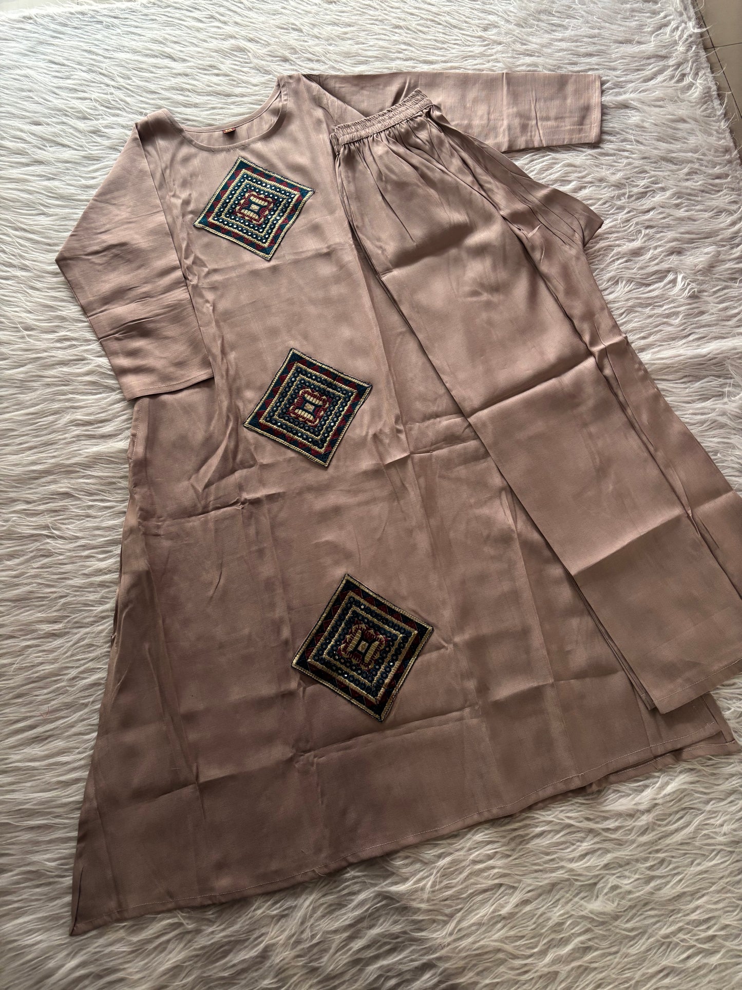 MD-234 This kurta set features striking geometric patchwork, blending traditional craftsmanship with a clean, contemporary silhouette. Perfect for those who appreciate the beauty of subtle details.