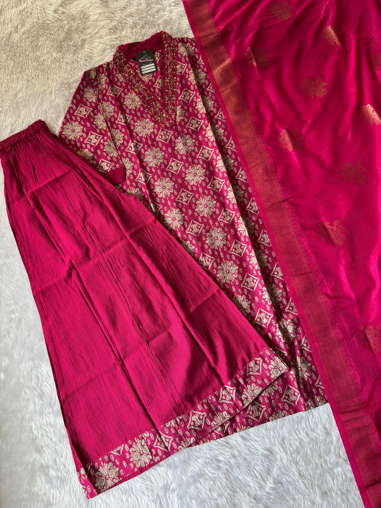 MD-171 "Regal Rose Banarasi Ensemble"

This elegant design features a rich magenta kurta adorned with intricate golden motifs, paired with a matching pleated bottom and a luxurious silk dupatta — perfect for festive elegance and timeless tradition.