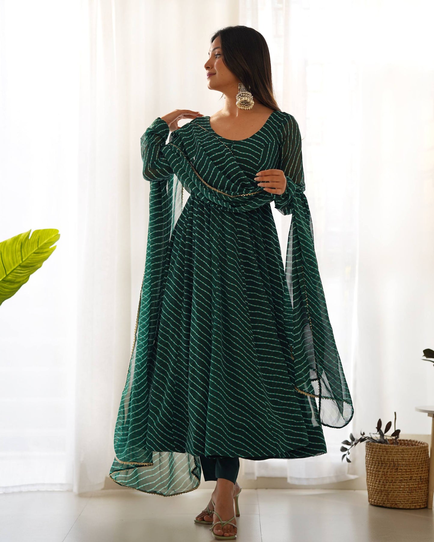MD-246 Step into a world of grace and sophistication with this stunning teal Leheriya-patterned Anarkali set. Perfect for festive celebrations or an elegant evening out, this ensemble strikes the perfect balance between traditional craftsmanship and moder