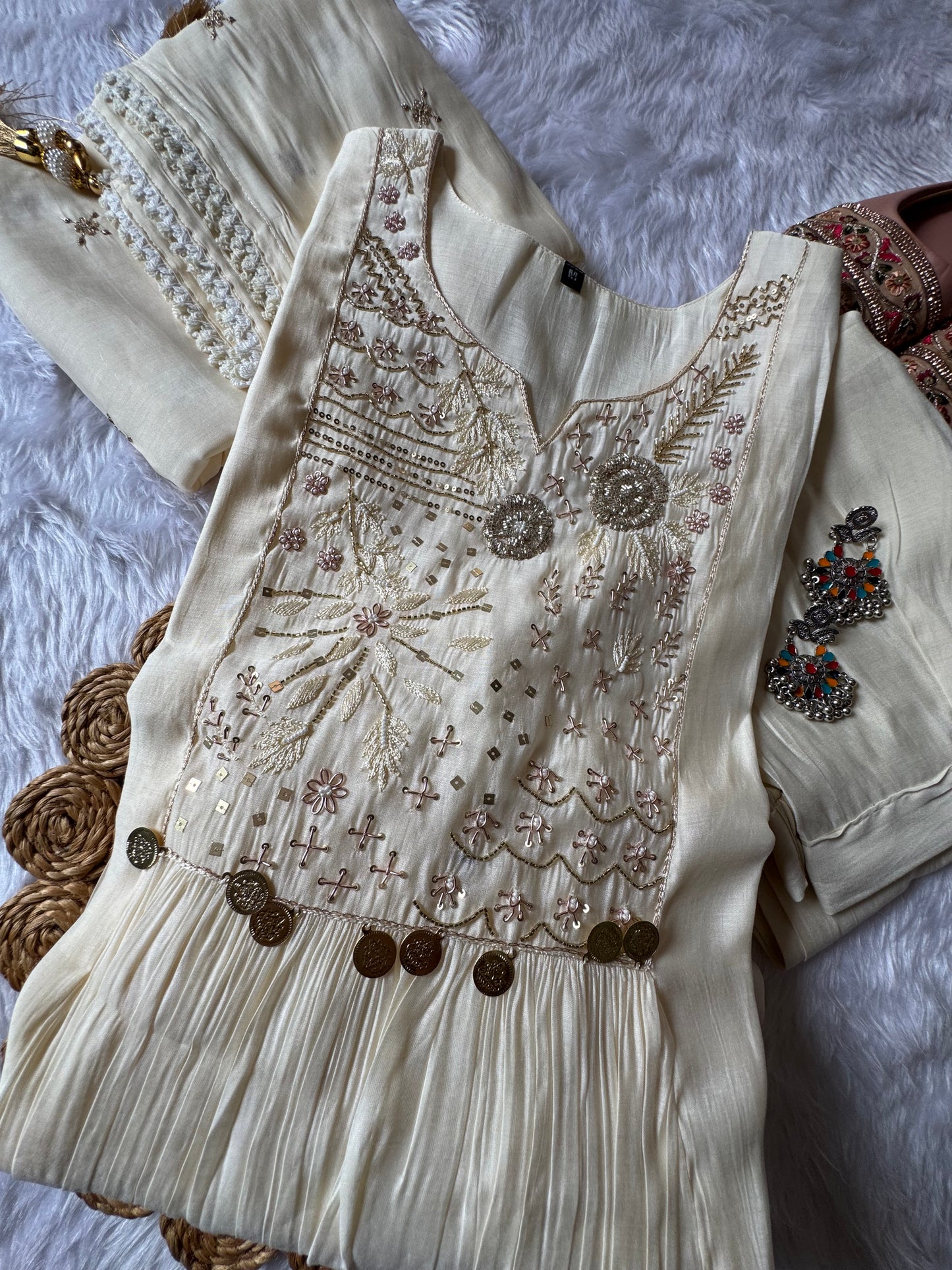 MD-184 This elegant suit set features delicate thread embroidery and mirror accents, paired with a soft, flowy dupatta — perfect for timeless festive charm.