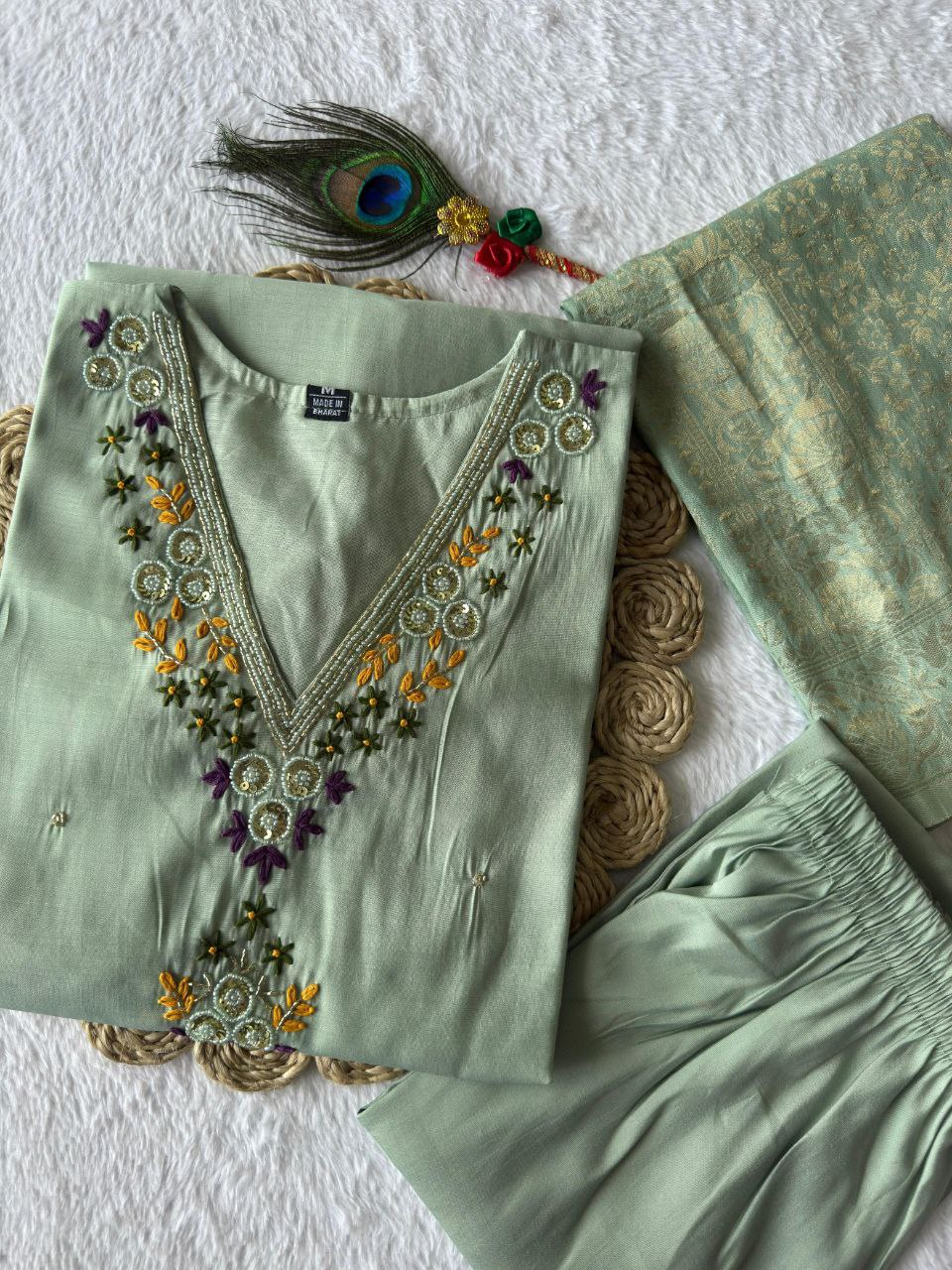 MD-239This sage green ensemble has a lovely, calming aesthetic. The V-neck embroidery and the peacock feather accent suggest a perfect blend of traditional craft and modern elegance.💜💥💫
